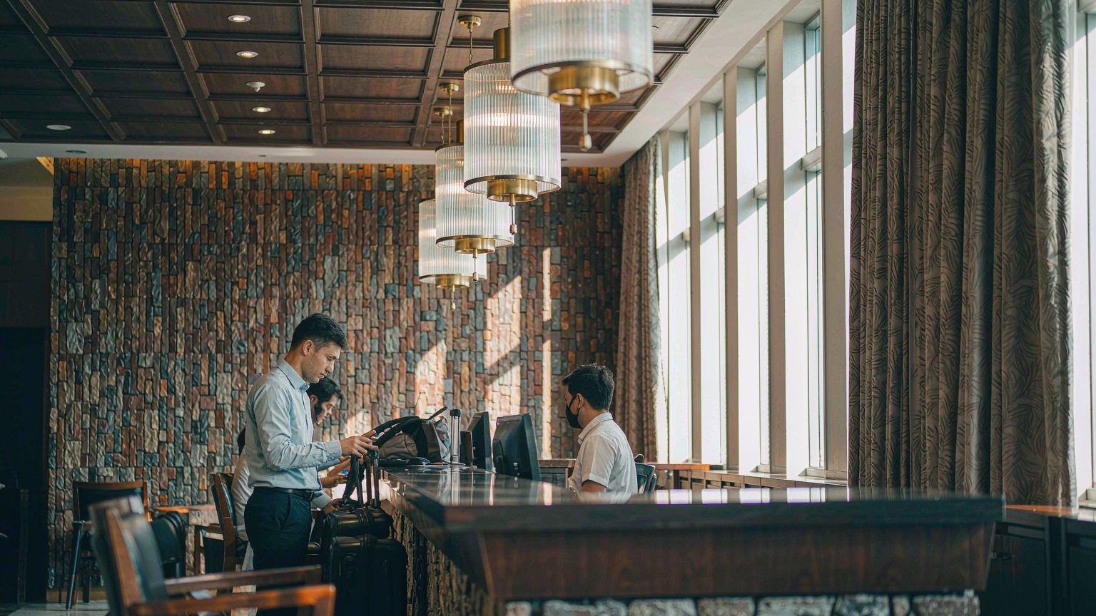 Hotel lobby with guests at the front desk
